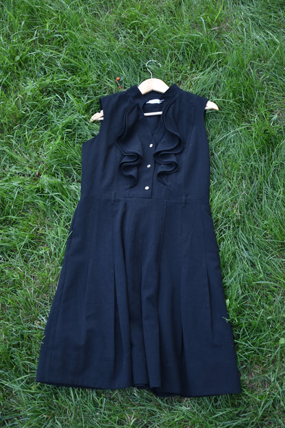 Sleeveless Black Dress with Pleats and Ruffle Trim Lapel